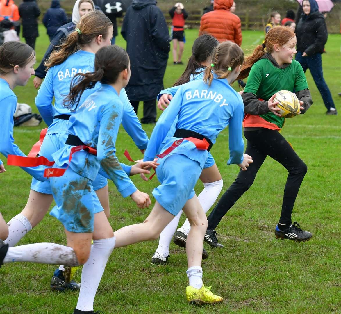Girls playing tag rugby in a school festival
